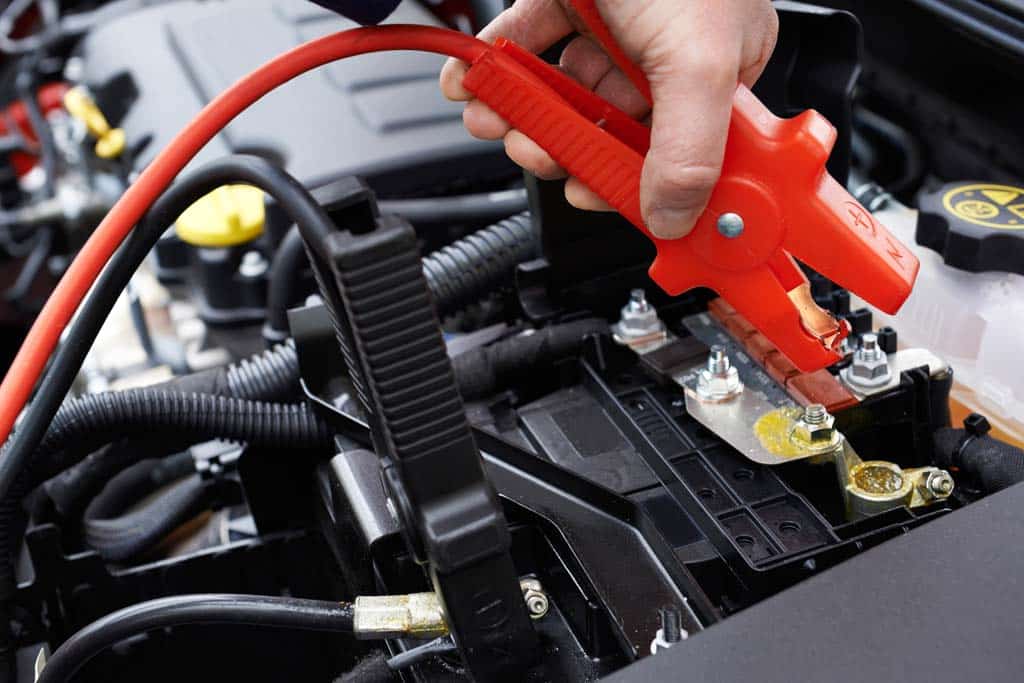Batería de coche siendo arrancada con cables