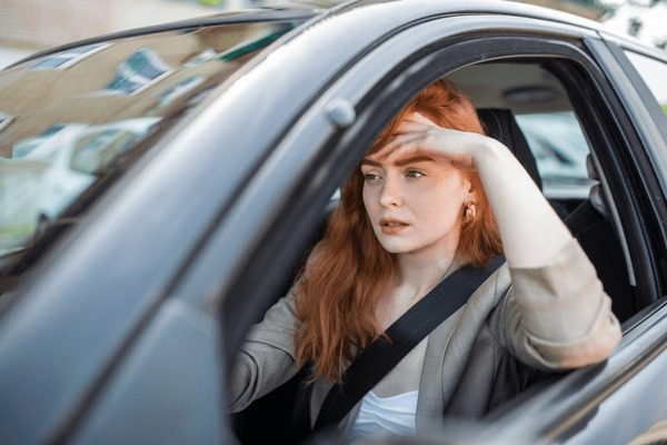 nervous female driver sits wheel 600nw 2155332327